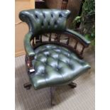 A reproduction Captains design green leather effect button upholstered armchair