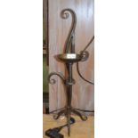A pair of hand made metal scrolling candlesticks 58 cm high