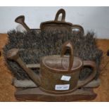 A decorative boot scraper in the form of a watering can