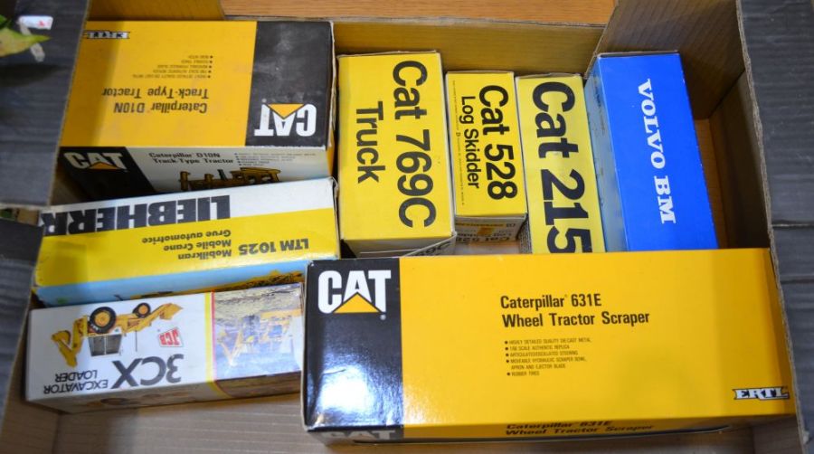 Eight various boxed Diecast vehicles to include Caterpillar 631E Wheel Tractor Scraper, Caterpillar