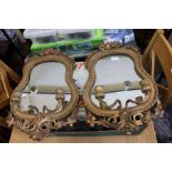 A pair of Continental giltwood mirror backed twin sconce girondells, 51cm long