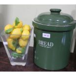 A BRG glazed lidded bread crock with a small glass vase of plastic lemons