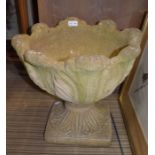 A pair of cast floral design pedestal urns