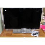 A 40 inch Samsung flat-screen TV with remote and instructions