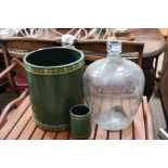 Two decorative tooled green leather covered cylindrical pots with a small carboy