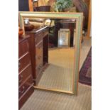 A modern green framed rectangular bevel plate wall mirror