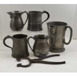 A collection of five pewter tankards and jugs, the largest piece engraved to the base Franklin Crow
