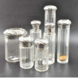 Seven silver topped bottles