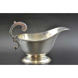 William Neale, A silver gravy boat, with scroll handle, Birmingham 1935, weight: 176g