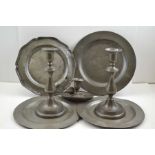 A pair of 19th century pewter push-rod candlesticks, four various pewter plates, one crested, and a