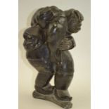 A 20th century Inuit soapstone carving of a figure, carrying a seal over his shoulder, inscribed "Sa