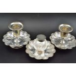 A Victorian silver desk set, comprising a pair of candlesticks, and an inkwell