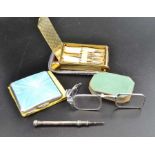An Art Deco design combination powder compact, lipstick holder with musical movement, a silver and g