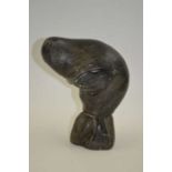 A 20th century Inuit soapstone carving of a seal, the base signed "Sakaraise",18cm high