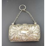 An Edwardian embossed silver purse, having green fabric interior and chain handle, Birmingham 1901,