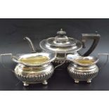 William Hayes, An Edwardian silver three-piece tea set of fluted Georgian design, bears crest, Birmi