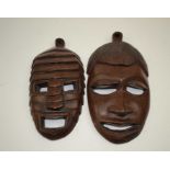 Two African carved wood wall masks, the tallest 20cm