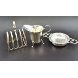 Barker Brothers Silver Ltd. A silver toast rack, Birmingham 1936, together with; a silver cream jug,