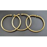 Three torc form bangles possibly from Guyana, test as 9ct, possibly with a steel core, combined weig