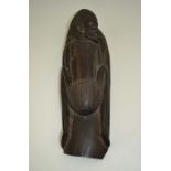 A 20th century carved wood of an African squatting figure, 27cm