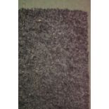 A dark ground large shaggy rug