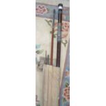 A canvas cased vintage mahogany fishing rod