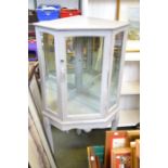 A grey painted corner display cabinet on legs