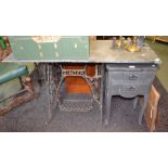 A Singer sewing machine treadle base, together with a slate top to form a table