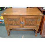 A reproduction oak low "Old Charm" storage unit with two door frontage