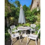 A white painted metal outdoor garden table together with four chairs & an umbrella