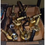 A box containing seven vintage blowtorches