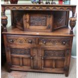 A well made reproduction carved oak court cupboard of typical design and construction