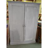 A large grey painted pine cupboard with three interior shelves
