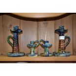 Two pairs of 'Art Pottery' candlesticks in the style of A Lauder of Barnstable