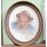 A watercolour portrait of a fisherman in oval gilt frame - faint signature
