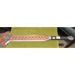 A double edged red painted and brass decorated combat re-enactment weapon