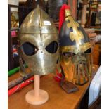 Two predominately brass combat re-enactment helmets