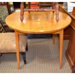 A light oak circular topped kitchen table on 4 plain legs