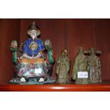 A collection of Oriental figurines, three bronze and the other porcelain