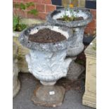 A pair of cast concrete pedestal urn planters
