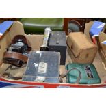 A box containing a selection of vintage cameras and optical related items