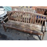 A three piece garden suite slatted teak construction, three person bench and two armchairs