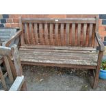 A slat built two person garden bench