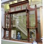 An Edwardian mahogany framed multi bevelled mirror backed display shelf