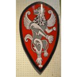 A metal shield with red ground and black and white lion motif