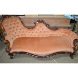 A Victorian well carved walnut framed chaise settee with peach velour button back