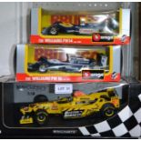 Three boxed die-cast Formula 1 cars