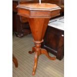 An octagonal sewing table with inlaid chess board top. Large hollow column on three legs