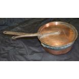 A 19th century copper saucepan with lid, fitted iron handles, the lid engraved 'Montmery', pan dia 2