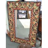A carved and painted large wall mirror